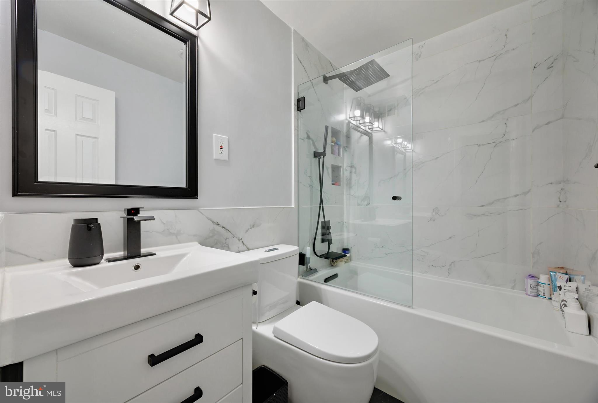 11406 Accolade Terrace Clinton, MD 20735 - Photo 18 of 45 a bathroom with a bathtub shower sink mirror vanity and toilet