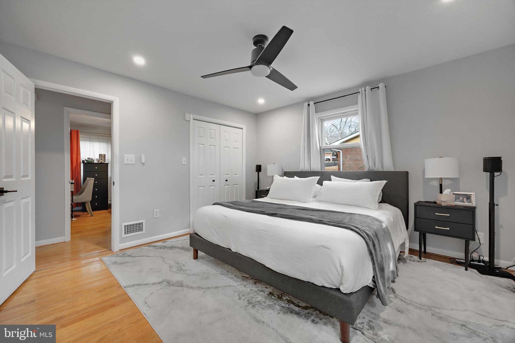 11406 Accolade Terrace Clinton, MD 20735 - Photo 21 of 45 a spacious bedroom with a bed and a chandelier