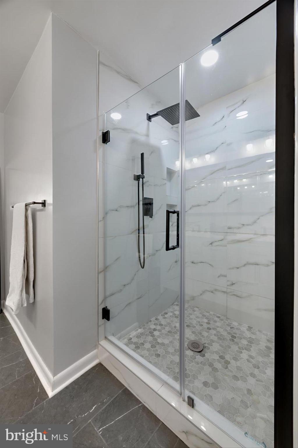 11406 Accolade Terrace Clinton, MD 20735 - Photo 23 of 45 a bathroom with a glass shower door