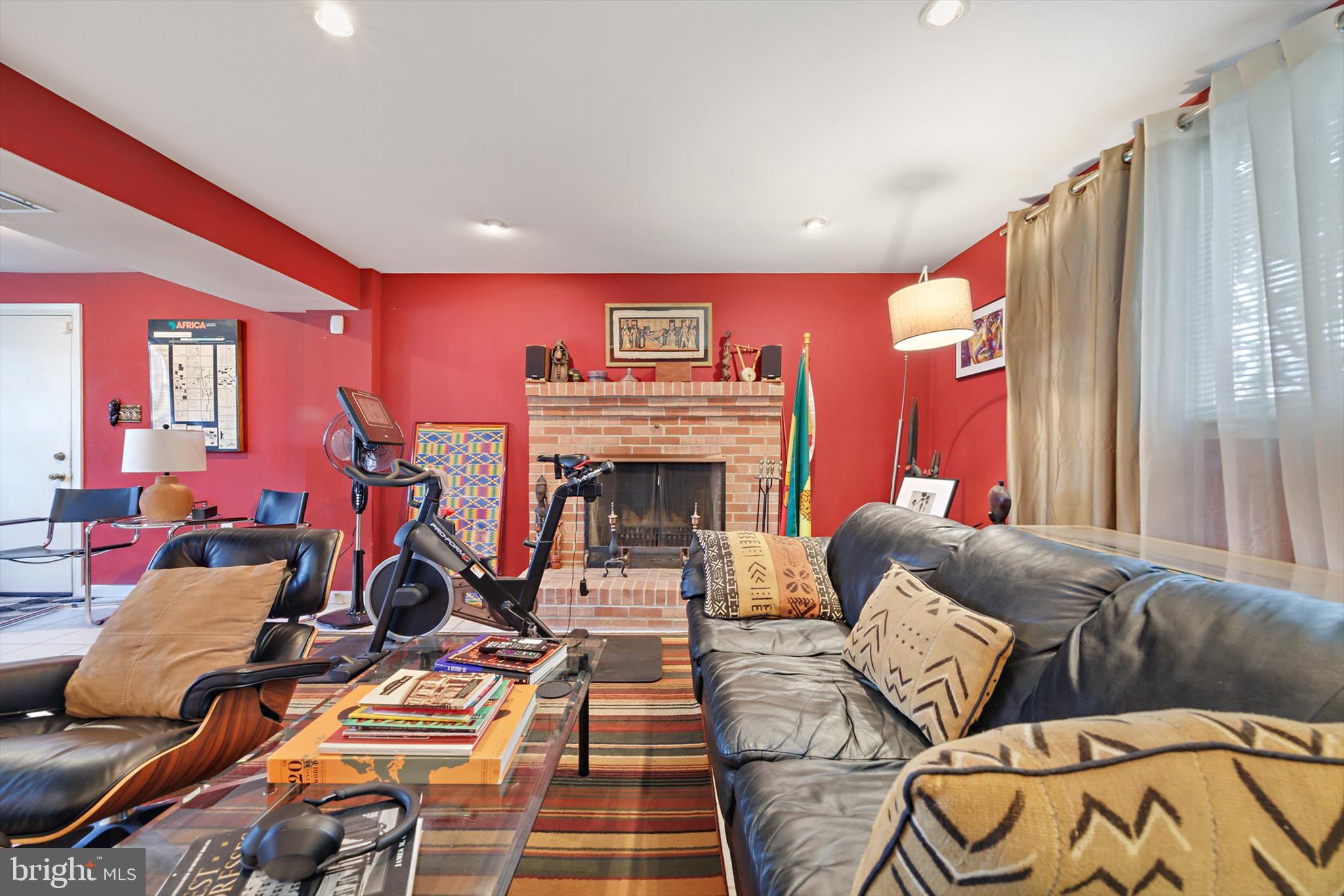 11406 Accolade Terrace Clinton, MD 20735 - Photo 38 of 45 a living room with furniture a fireplace and a flat screen tv