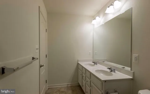 a bathroom with a sink and mirror
