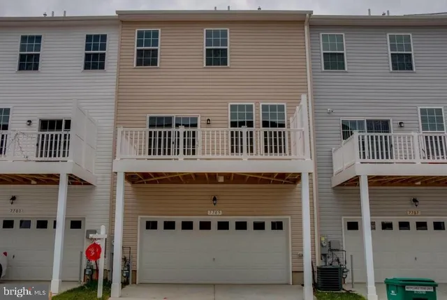 a large building with a door and balcony