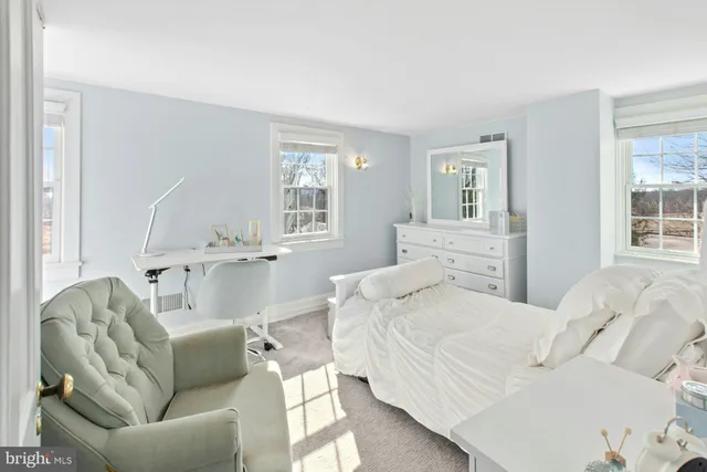 a bedroom with a bed couch and window