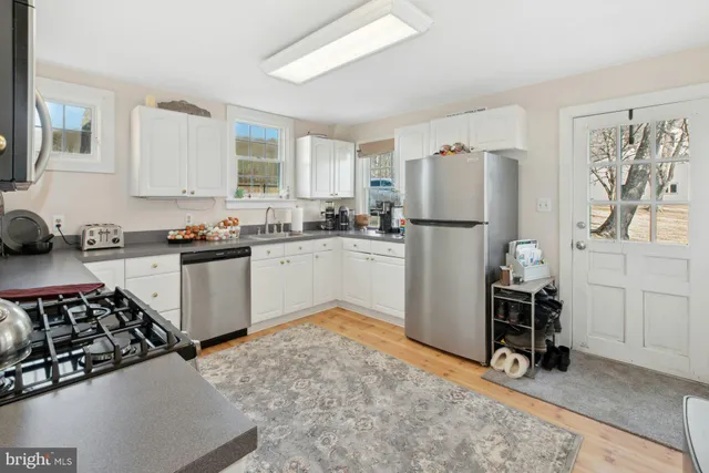 a kitchen with a sink appliances and cabinets