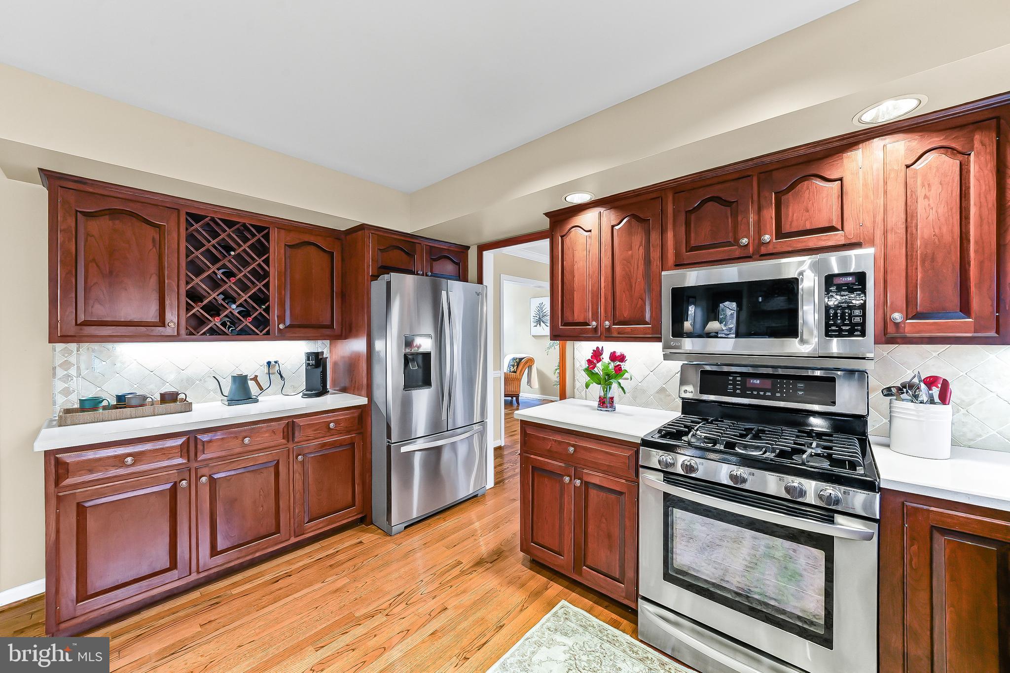 5 Copper Beech Court Landenberg, PA 19350 - Photo 13 of 38 a kitchen with stainless steel appliances wooden cabinets and a stove top oven