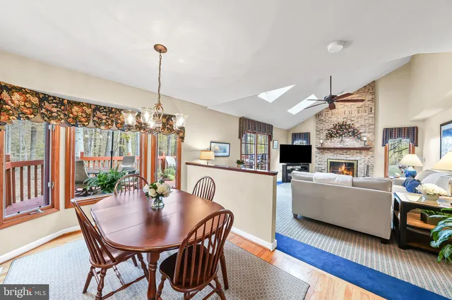 a living room with furniture a flat screen tv and a table