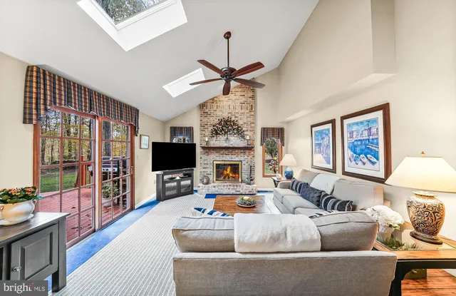 a living room with furniture a fireplace and a flat screen tv