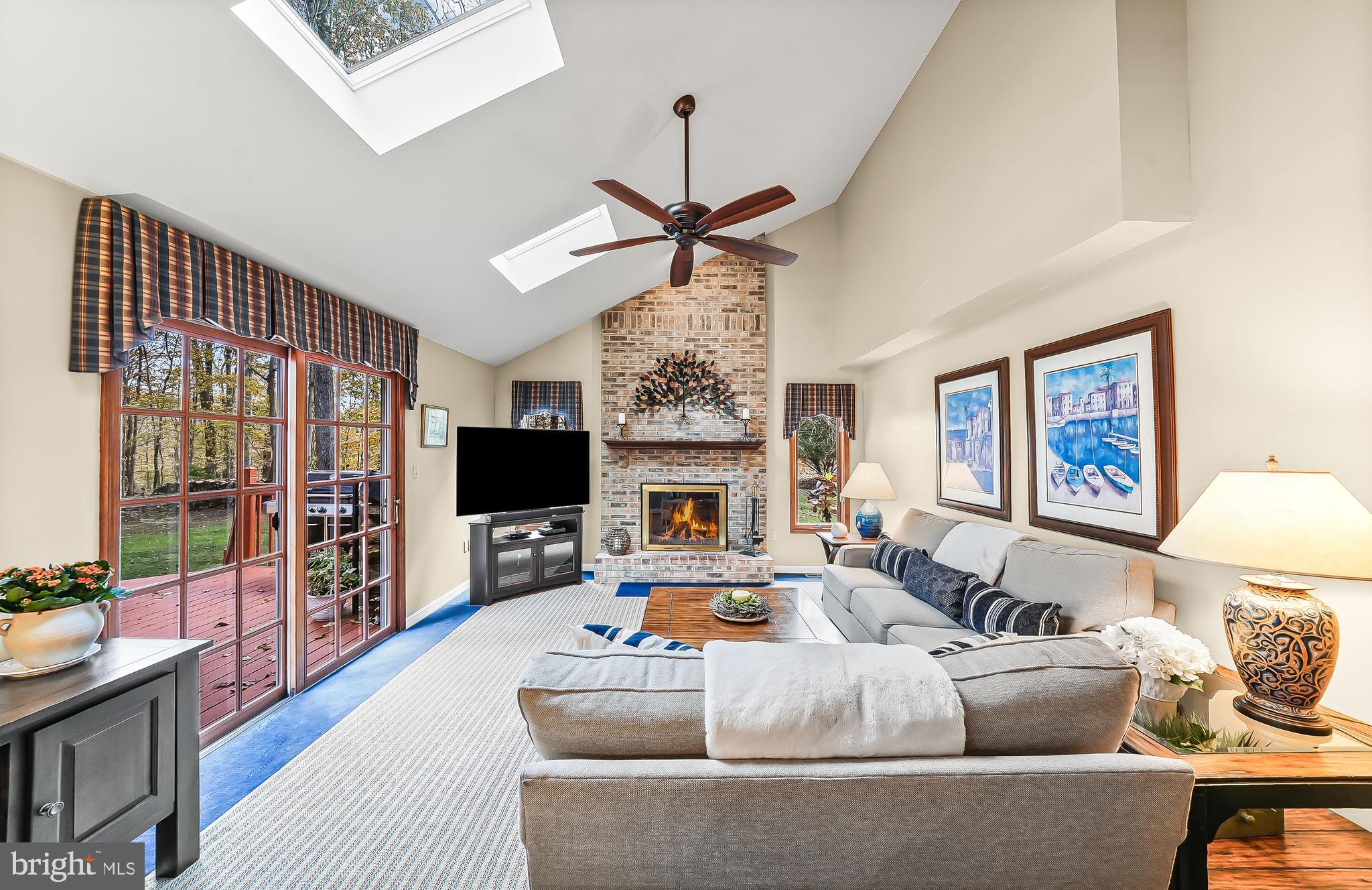 5 Copper Beech Court Landenberg, PA 19350 - Photo 17 of 38 a living room with furniture a fireplace and a flat screen tv