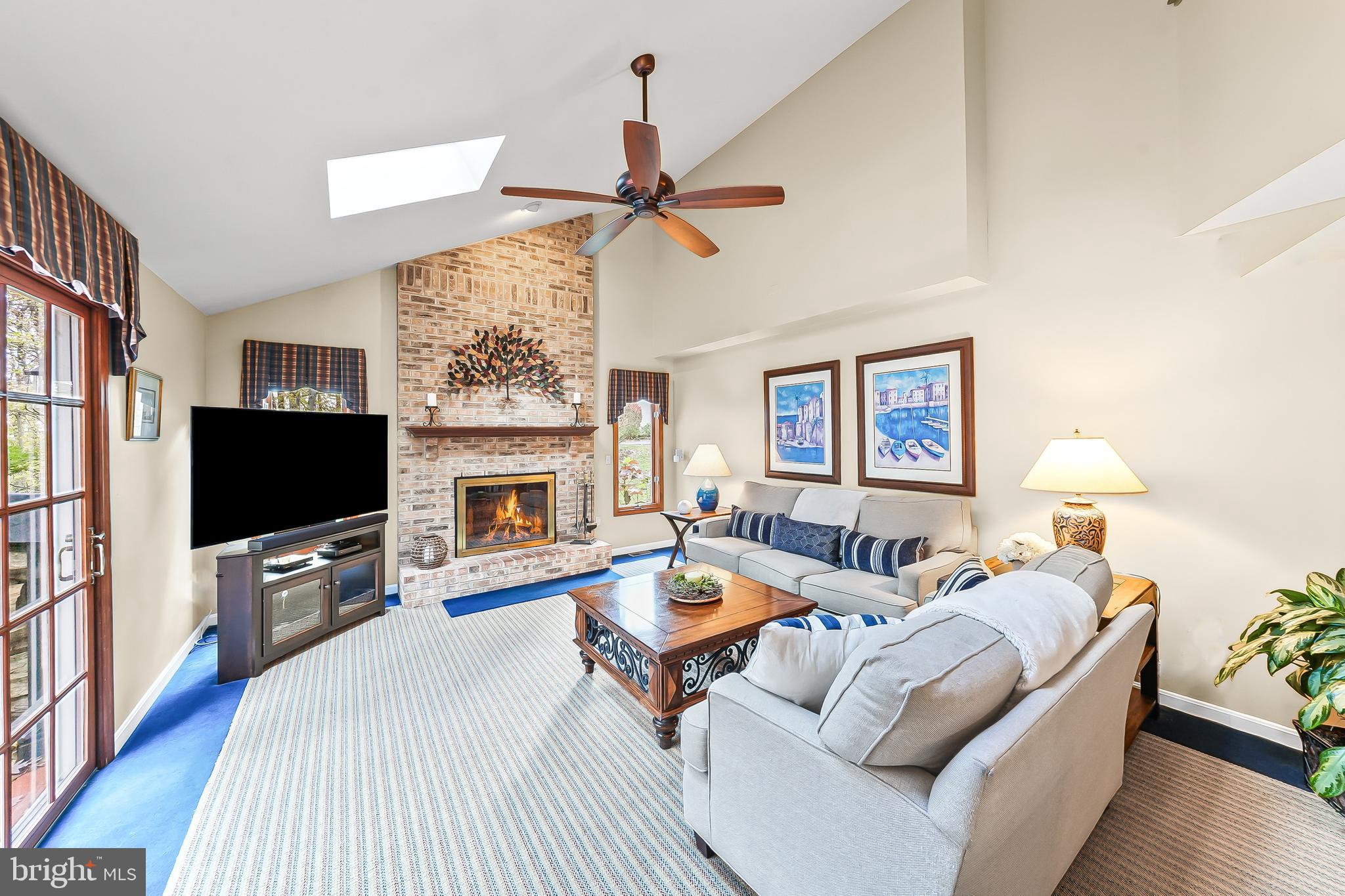 5 Copper Beech Court Landenberg, PA 19350 - Photo 19 of 38 a living room with furniture a flat screen tv and a fireplace