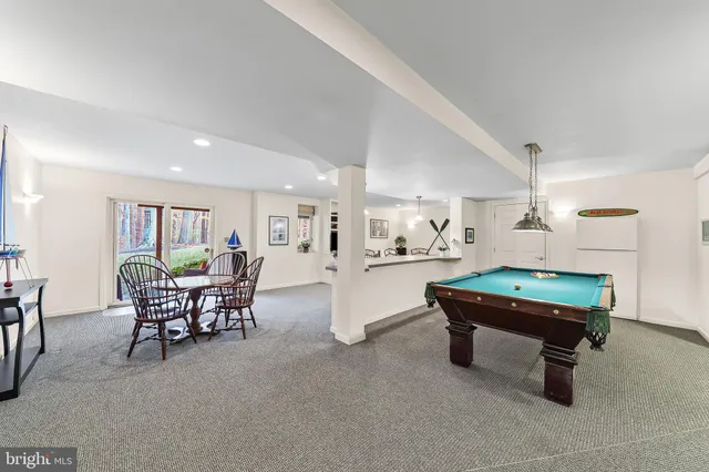 a room with furniture and pool table