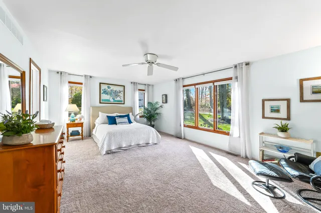 a spacious bedroom with a bed and a large window