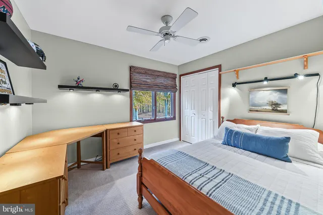 a spacious bedroom with a bed and a chandelier