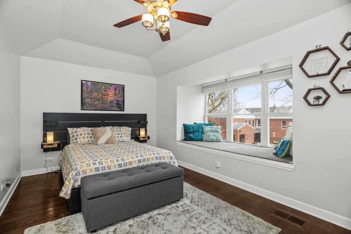1811 Lyons Street Evanston, IL 60201 - Photo 17 of 33 a bedroom with a large bed and a chandelier