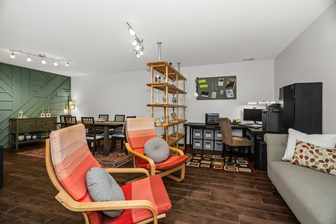 1811 Lyons Street Evanston, IL 60201 - Photo 26 of 33 a living room with furniture a rug and a bookshelf