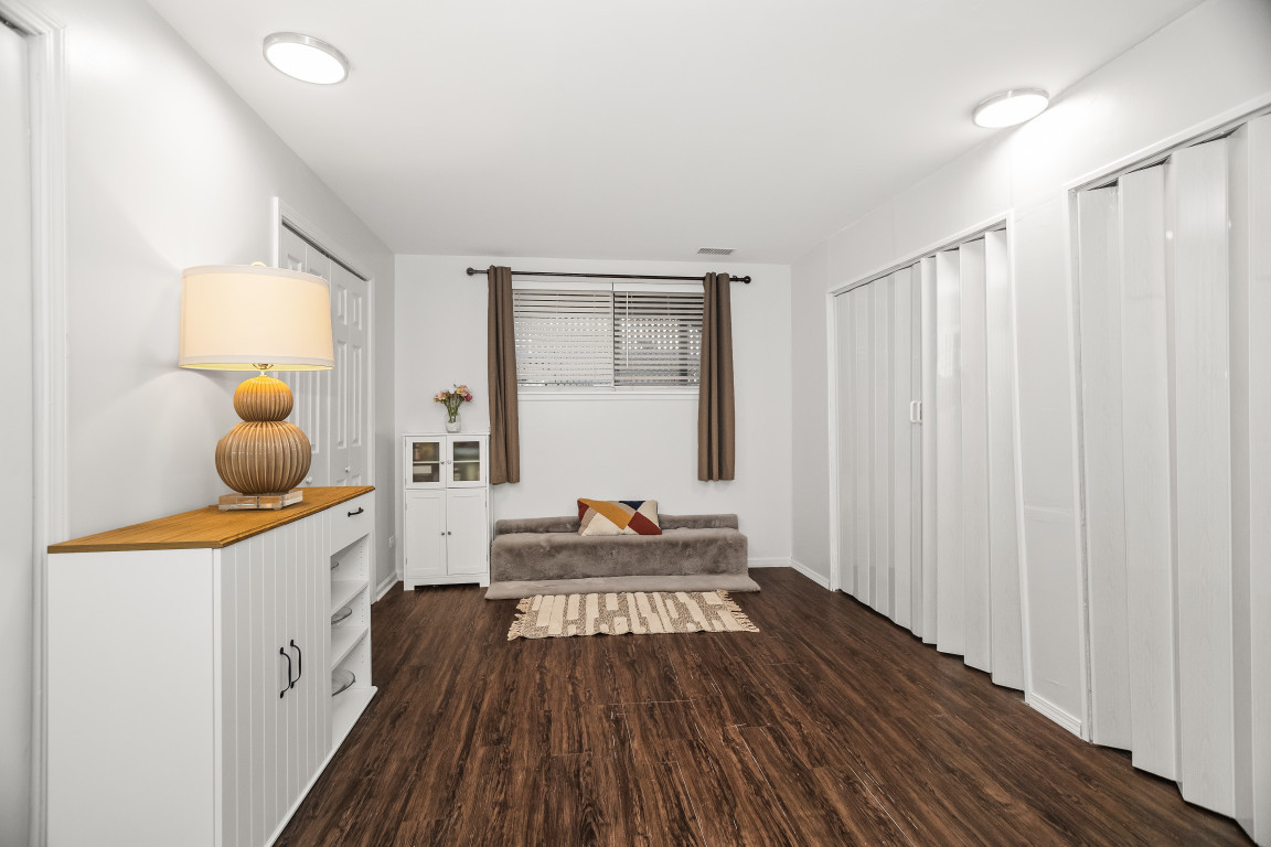 1811 Lyons Street Evanston, IL 60201 - Photo 27 of 33 a hallway with a wooden floor and furniture