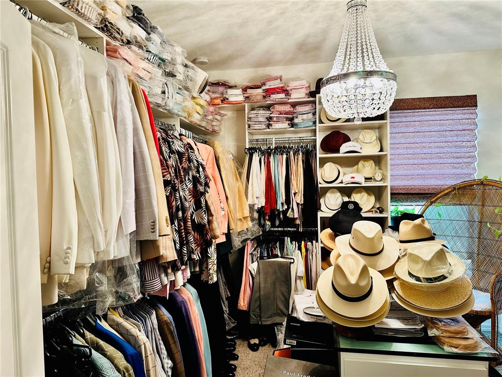 944 Old Windsor Way Spring Hill, FL 34609 - Photo 17 of 31 a view of walk in closet with clothes and shoes