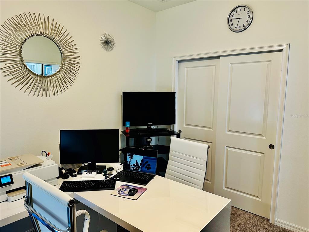 944 Old Windsor Way Spring Hill, FL 34609 - Photo 19 of 31 a room with furniture and a flat screen tv
