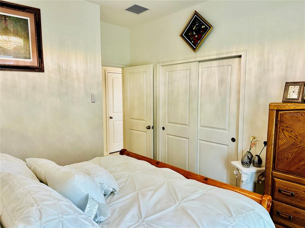 944 Old Windsor Way Spring Hill, FL 34609 - Photo 21 of 31 a bedroom with a bed and furniture