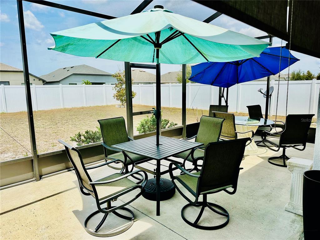 944 Old Windsor Way Spring Hill, FL 34609 - Photo 25 of 31 a view of an outdoor sitting area with furniture and umbrella