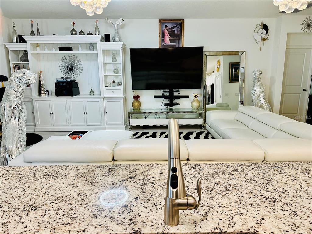 944 Old Windsor Way Spring Hill, FL 34609 - Photo 5 of 31 a living room with furniture and a flat screen tv