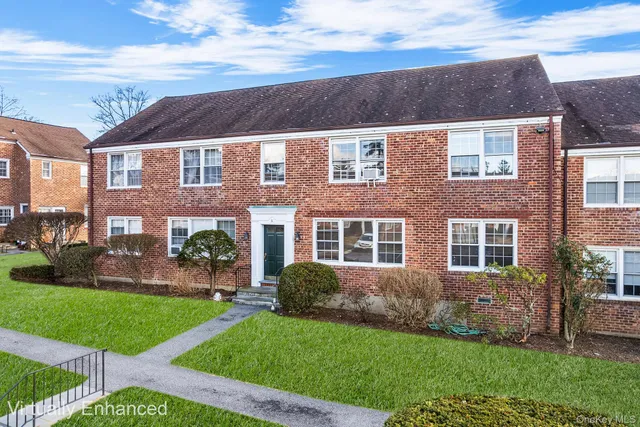 a view of a brick building next to a yard