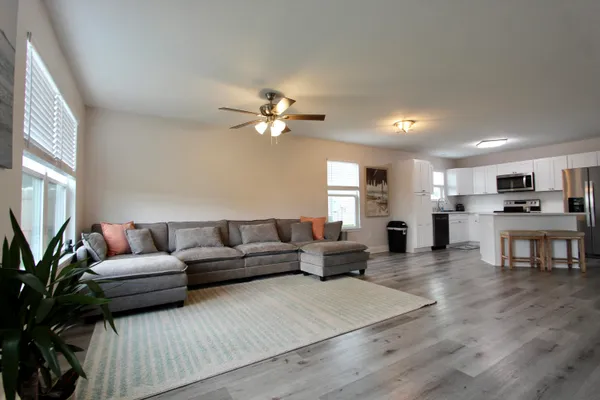 a living room with furniture and kitchen view