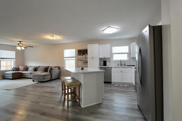 a kitchen with white cabinets and stainless steel appliances