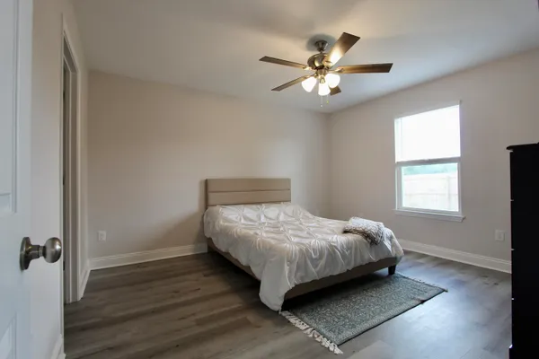 a bedroom with a bed and a chandelier