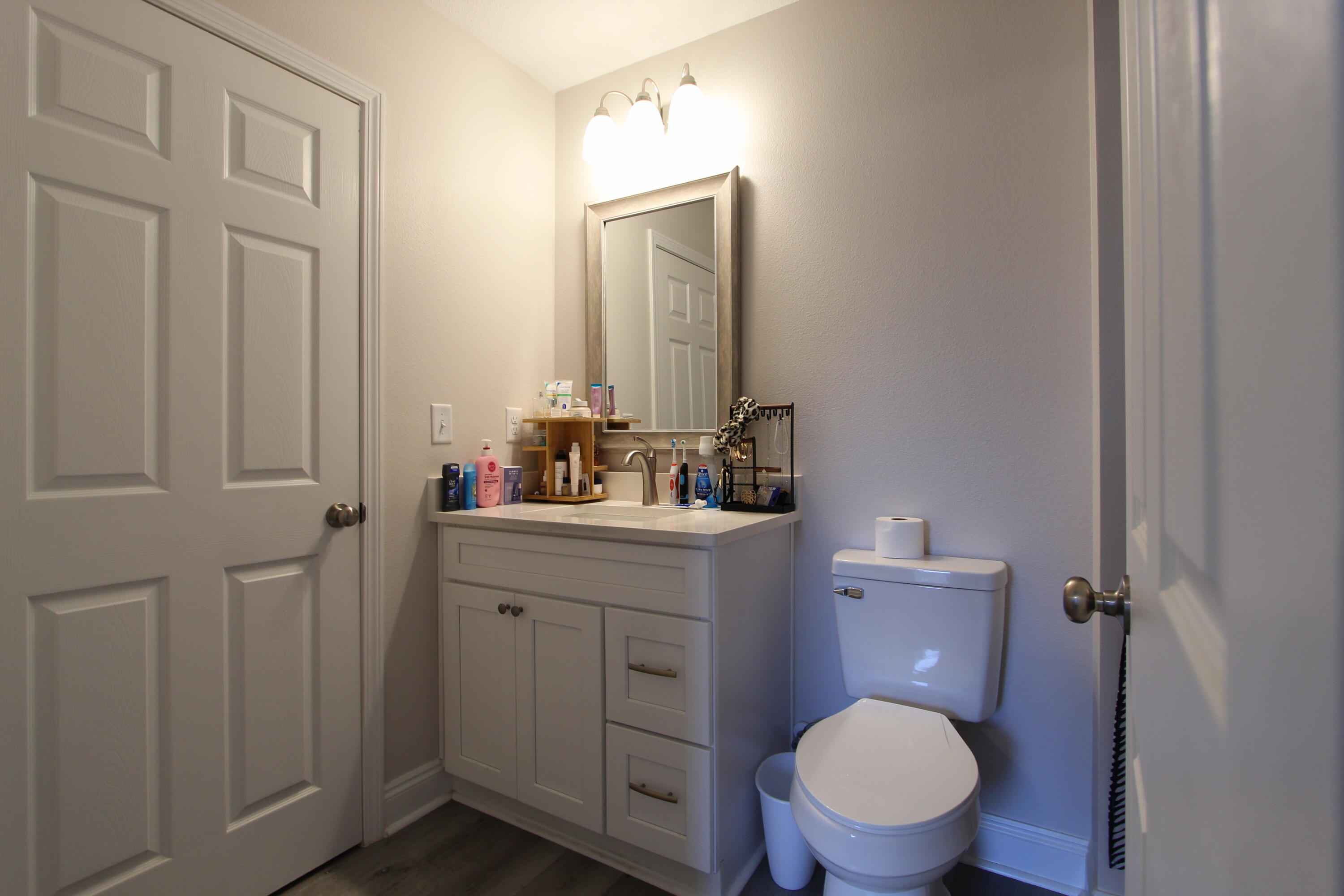 5366 Highview Drive Crestview, FL 32539 - Photo 14 of 19 a bathroom with a toilet a sink a vanity and mirror