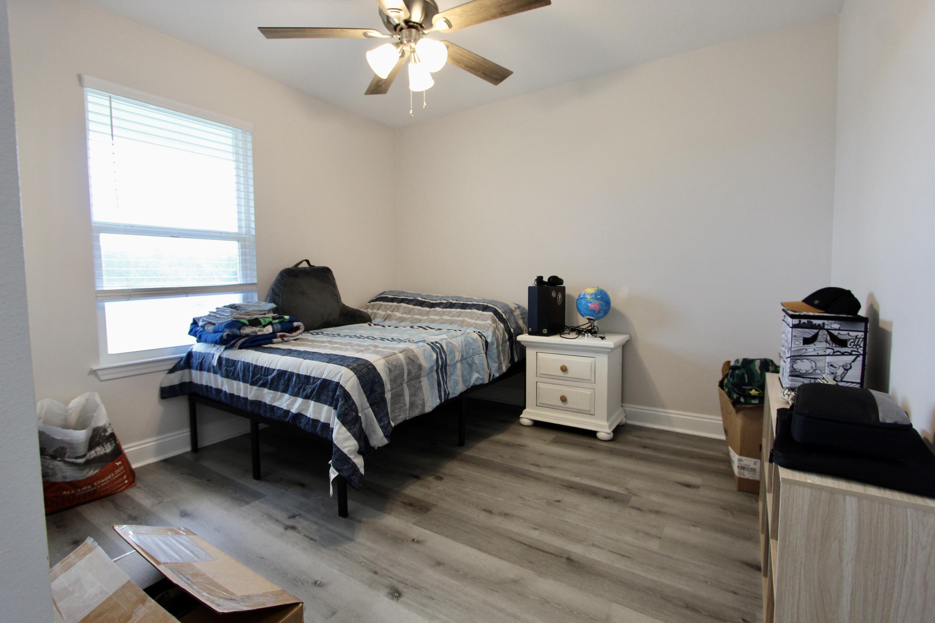 5366 Highview Drive Crestview, FL 32539 - Photo 15 of 19 a bedroom with a bed and a chandelier