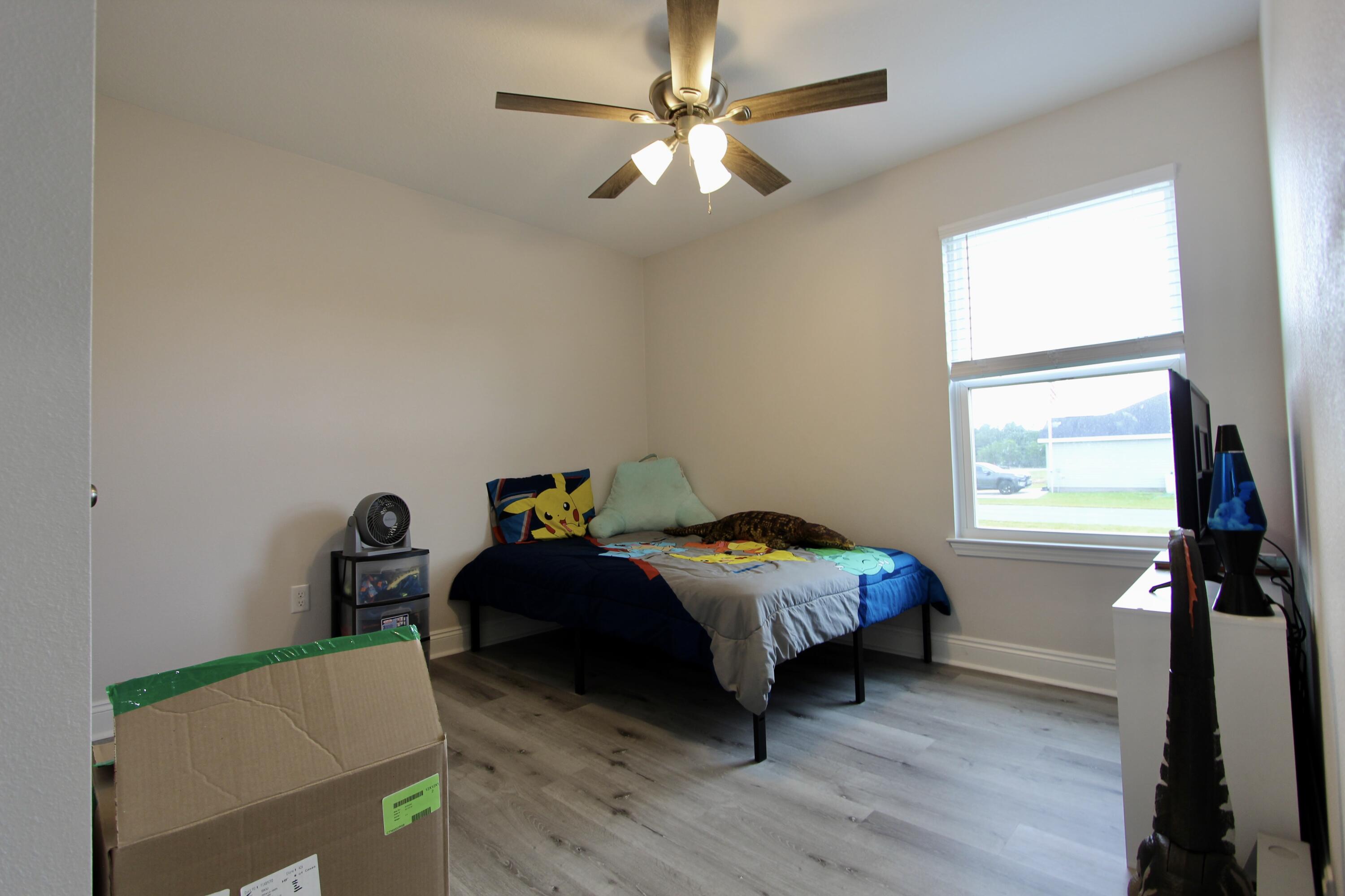 5366 Highview Drive Crestview, FL 32539 - Photo 16 of 19 a bedroom with a bed and a window