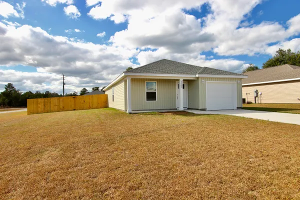 a view of a house with a backyard