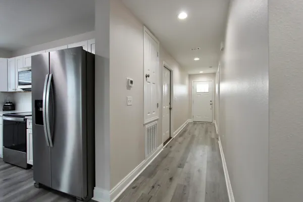 a view of a refrigerator in kitchen and wooden floor