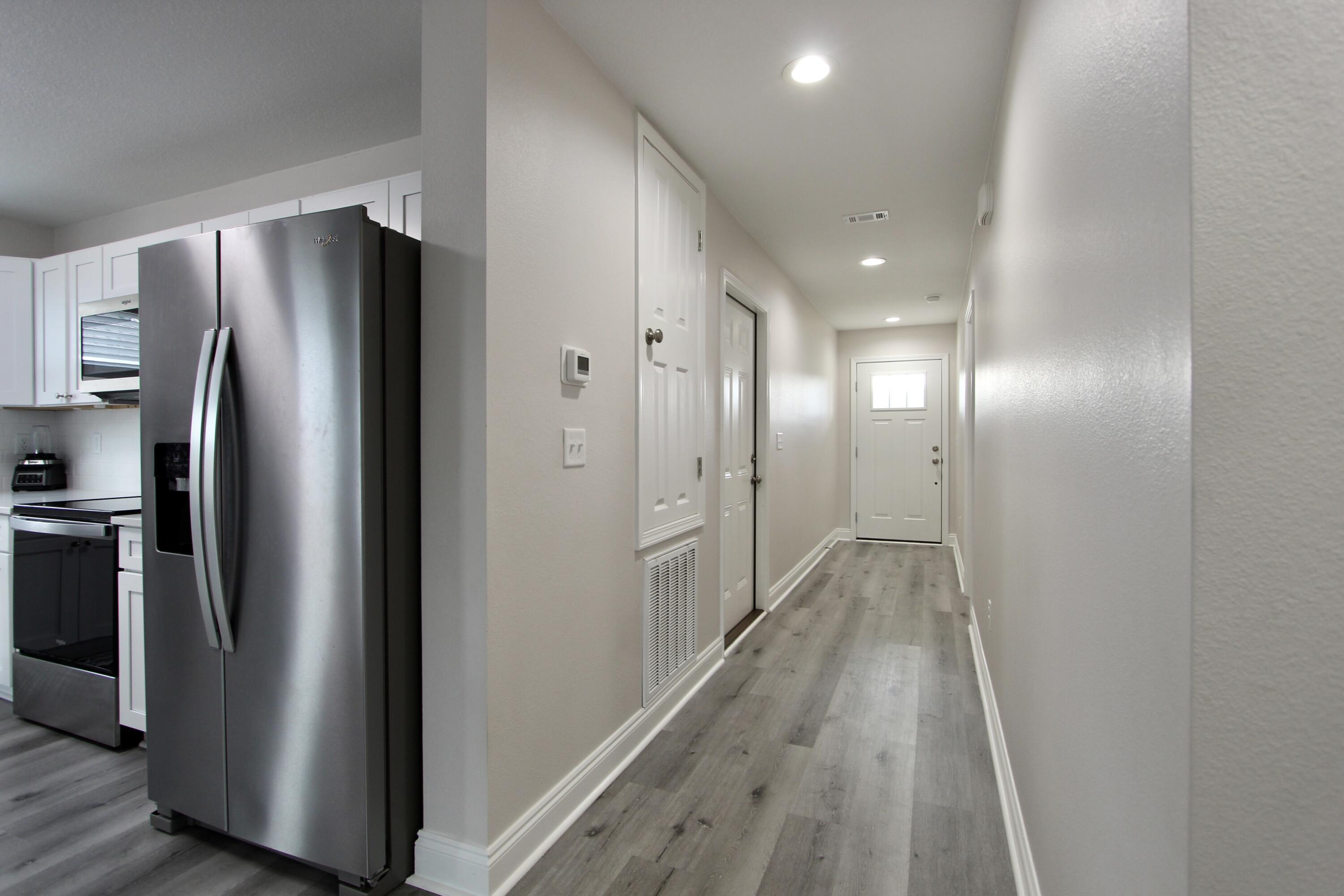 5366 Highview Drive Crestview, FL 32539 - Photo 5 of 19 a view of a refrigerator in kitchen and wooden floor