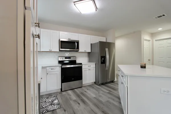 a kitchen with a refrigerator stove and sink