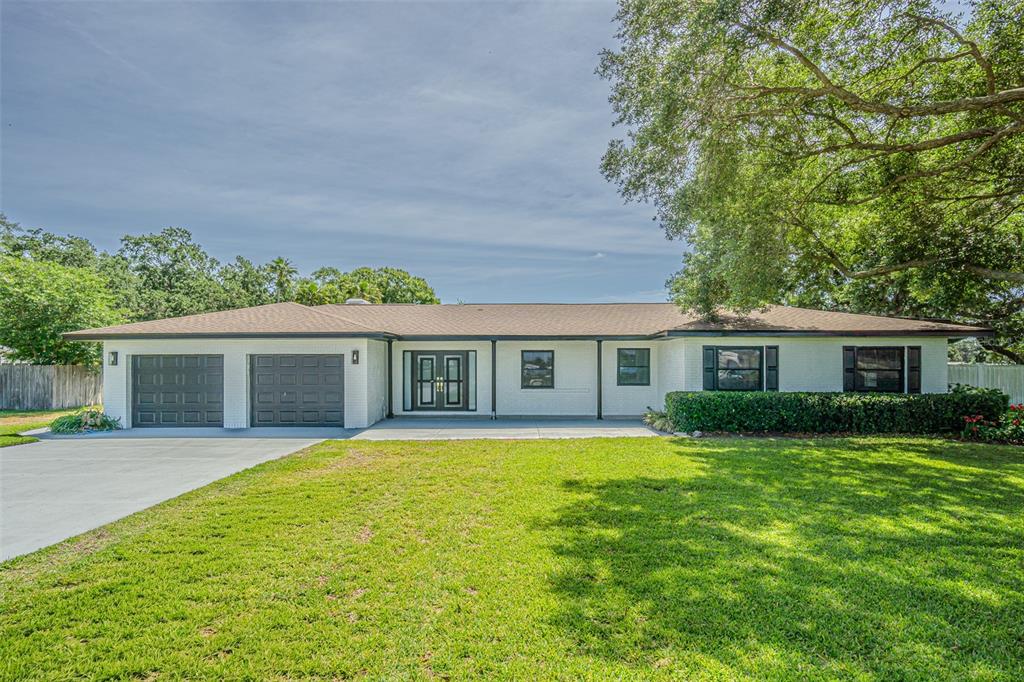 5302 Turkey Creek Road Plant City, FL 33567 - Photo 1 of 46 a front view of house with yard and green space