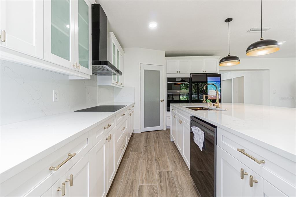 5302 Turkey Creek Road Plant City, FL 33567 - Photo 5 of 46 a kitchen with cabinets and wooden floors