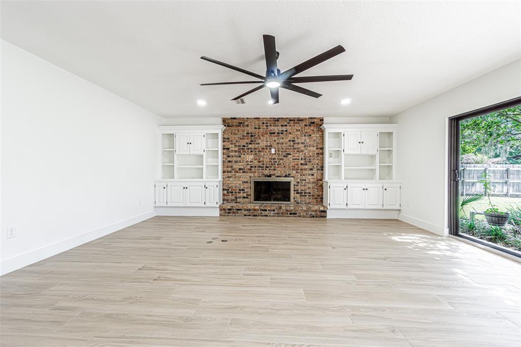 5302 Turkey Creek Road Plant City, FL 33567 - Photo 6 of 46 an empty room with windows and fireplace
