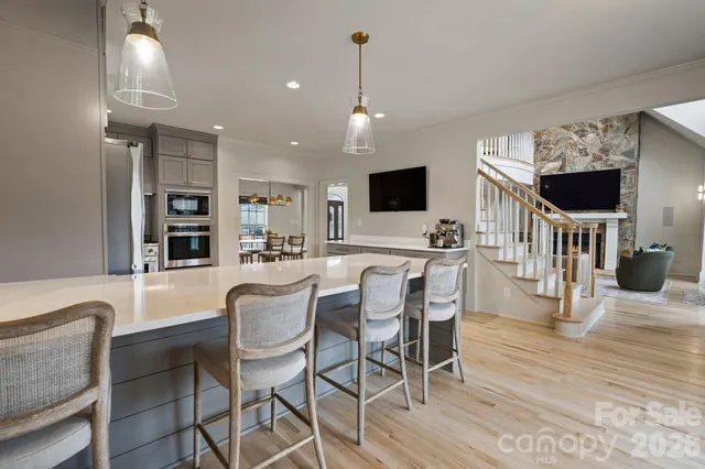 a dining room with furniture and wooden floor
