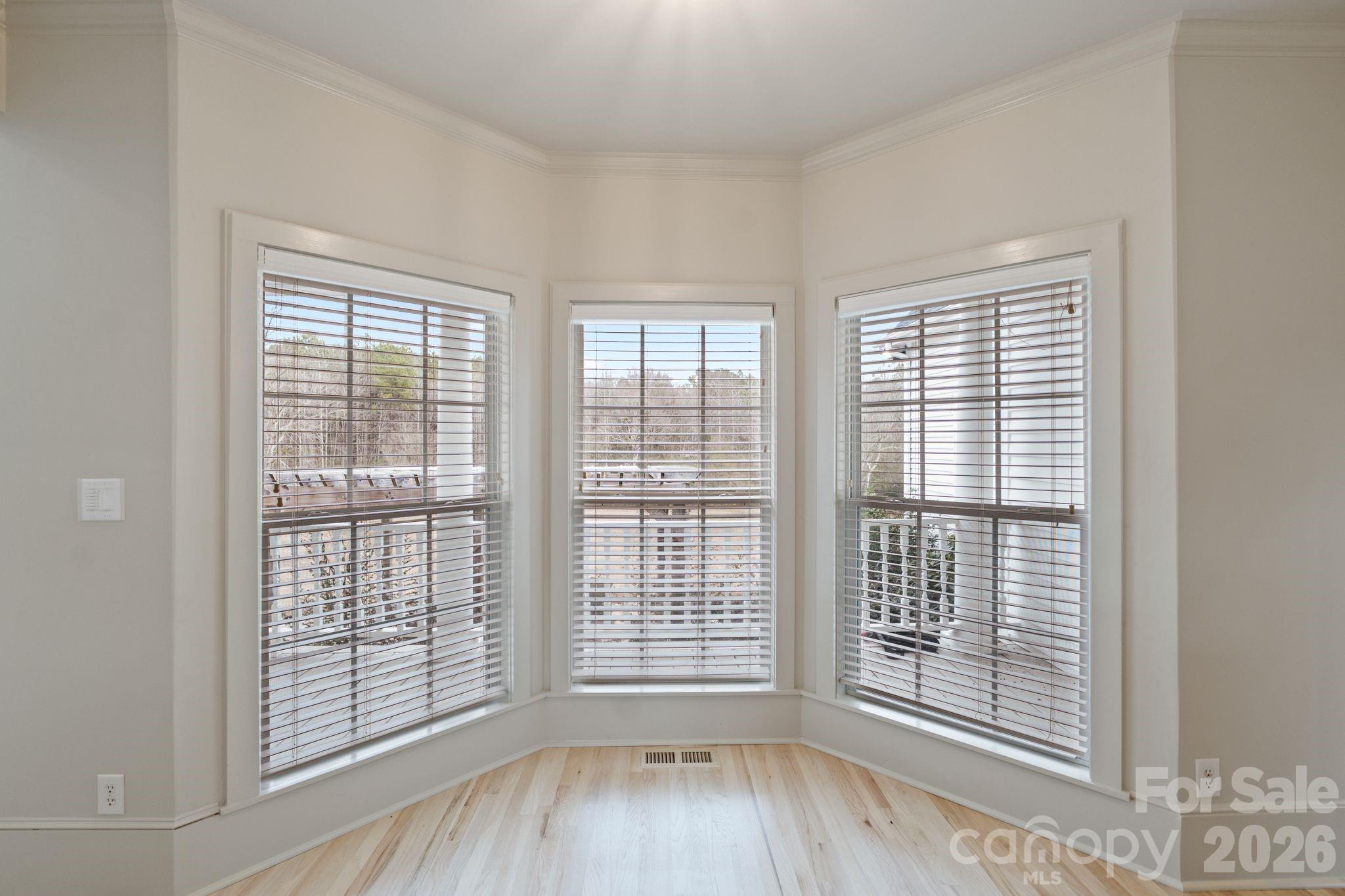 940 State Rd S-13-106 Pageland, SC 29728 - Photo 13 of 41 a view of an empty room with wooden floor and a window