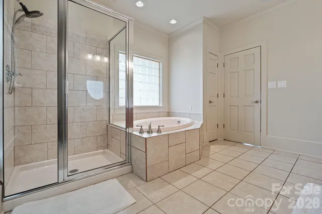 a bathroom with a bathtub and a shower