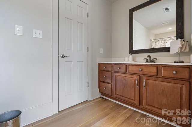 a spacious bathroom with a double vanity sink and a mirror