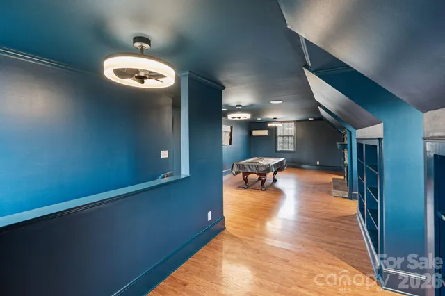 a view of a room with wooden floor