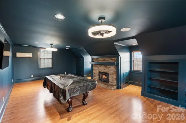 a living room with furniture a fireplace and a window