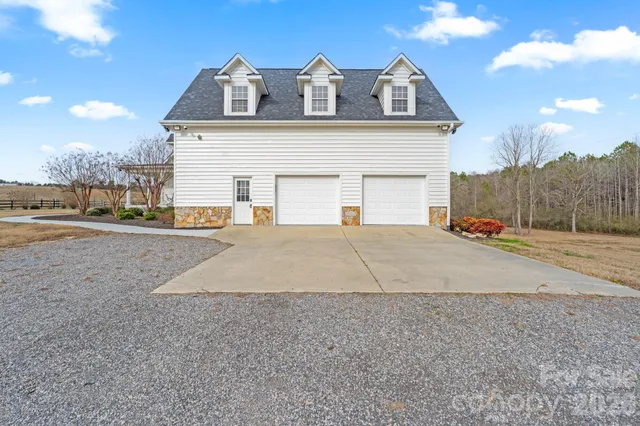 a view of a white house with a outdoor space
