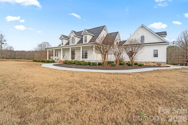 a front view of house with yard and trees around