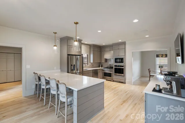 a large kitchen with a table and chairs in it