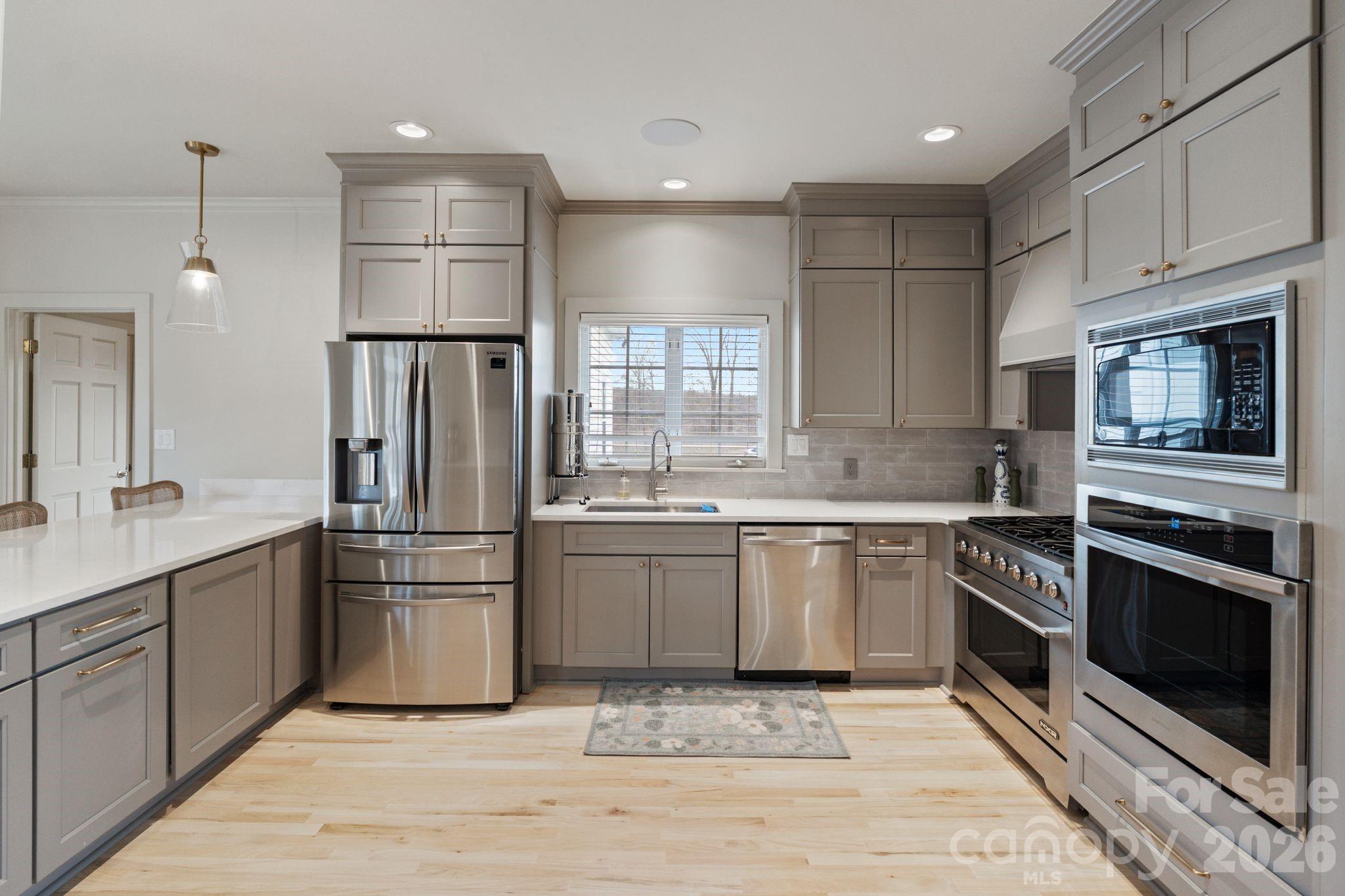 940 State Rd S-13-106 Pageland, SC 29728 - Photo 9 of 41 a kitchen with white cabinets and stainless steel appliances