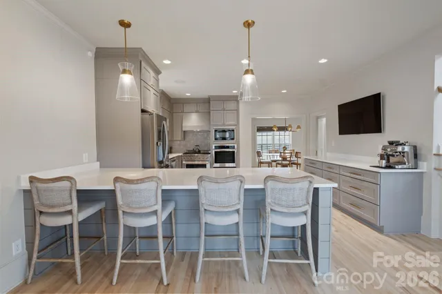 a large kitchen with a table and chairs