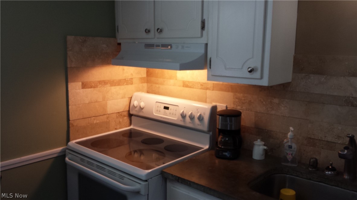 4619 15th Street Northwest Canton, OH 44708 - Photo 14 of 26 Kitchen with backsplash, sink, white range with electric stovetop, and custom range hood